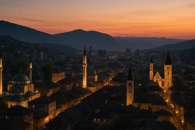 The city of Sarajevo is nestled in a valley, with the lights of houses climbing the surrounding hills, and the minarets and church towers of the old town glowing at dusk, Sarajevo Canton, Bosnia and Herzegovina.