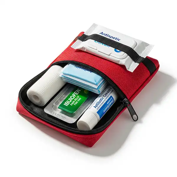 10 Essential Packing Hacks for Stress-Free Family Travel 9 An open, compact red first-aid pouch with bandages, antiseptic wipes, and medicine inside.
