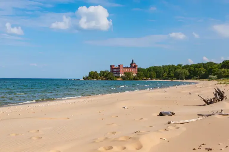 Halmstad 4 Halmstad beach and castle under a bright blue sky.
