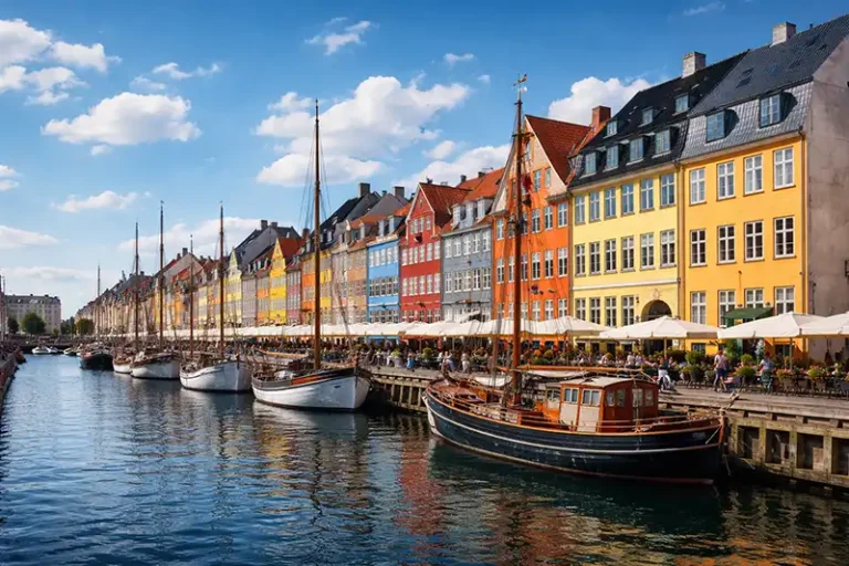 Copenhagen 3 Scenic view of colorful townhouses and sailboats at Nyhavn harbor in Copenhagen, Denmark.