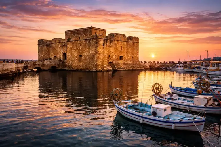 Paphos 1 The medieval Paphos Castle at the harbor entrance during a vibrant sunset.
