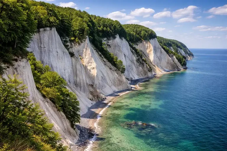 Zealand 1 Dramatic white chalk cliffs of Møns Klint on the coast of Zealand, Denmark, rising from the blue sea.