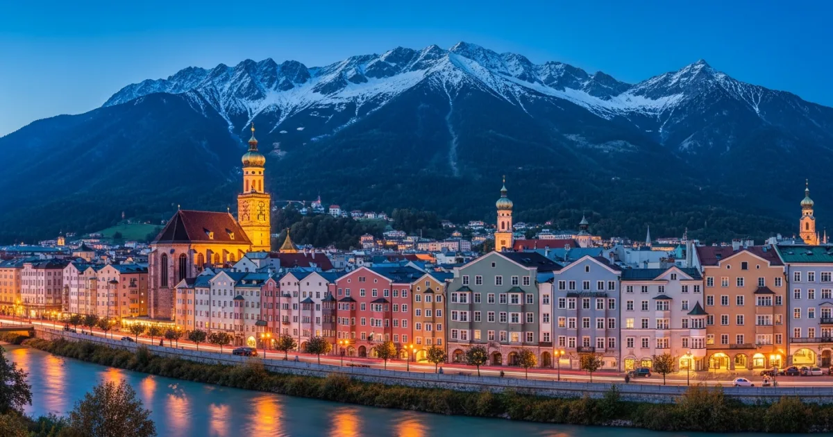 Twilight view of Innsbruck's historic Old Town with the snow-capped Nordkette mountains in the background