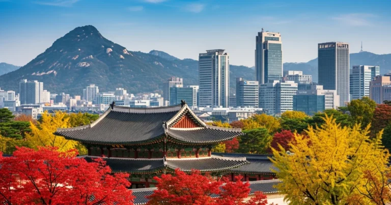 South Korea 3 Gyeongbokgung Palace in Seoul surrounded by autumn foliage and modern skyscrapers