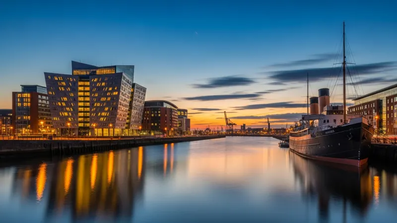 Beyond the Titanic: Exploring Maritime Belfast 1 The Titanic Belfast building and SS Nomadic ship at dusk.