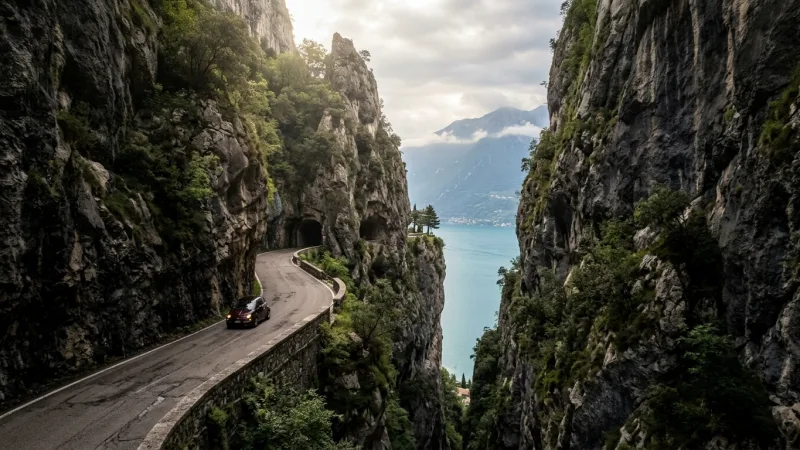 A narrow road cut directly into a rocky mountain gorge.