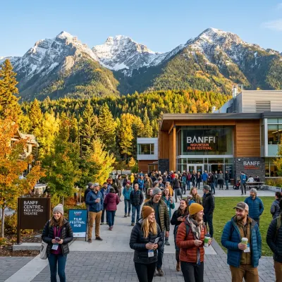Outdoor gathering of attendees at the Banff Centre with snow-capped mountain peaks in the background.