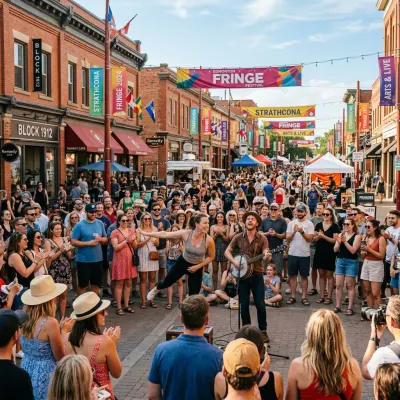 Crowds of spectators watching an outdoor street performance during the Edmonton International Fringe Theatre Festival.
