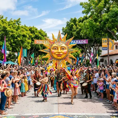 Performers with colorful costumes and a giant sun puppet at the Santa Barbara Summer Solstice Parade