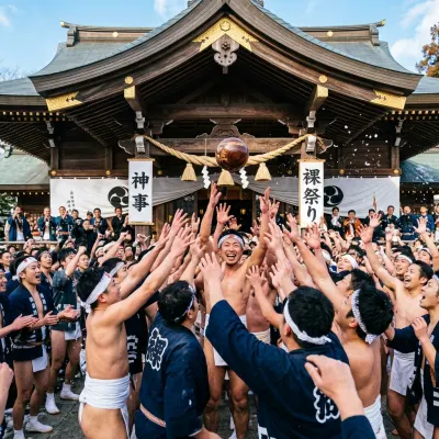 Festival participants competing to lift a sacred wooden ball during the Tamaseseri ritual at Hakozaki Shrine