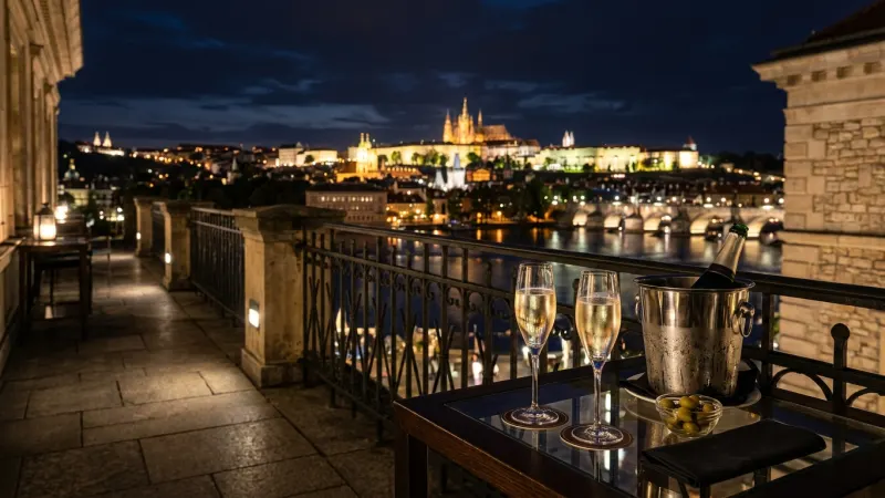 Pre-Order Intermission Refreshments for Exclusive Terrace Access 4 View from the Prague National Theatre upper terrace with an illuminated city skyline and Prague Castle in the distance.
