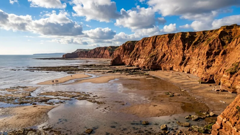 Time Beach Walks with Low Tide and Pack Red-Dirt Shoes 4 Red sandstone cliffs and expansive exposed sand flats at low tide on Prince Edward Island.