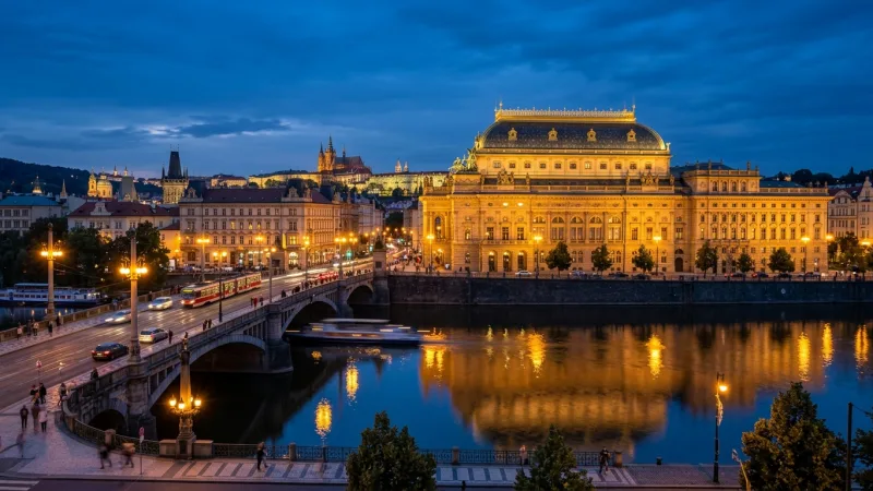 Verify the Specific Venue Before You Book 5 Exterior view of the historic National Theatre in Prague lit up along the Vltava riverbank at dusk.